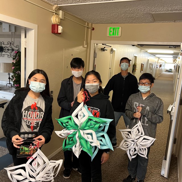 Alamitos AVID students deliver the snow flakes to the Senior Center.